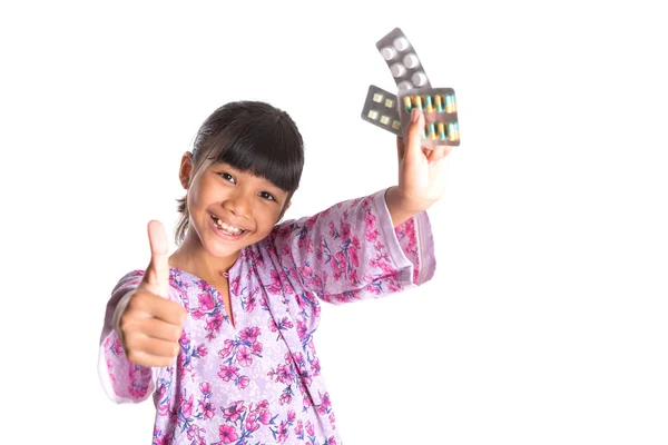 Menina jovem e comprimidos de medicina — Fotografia de Stock