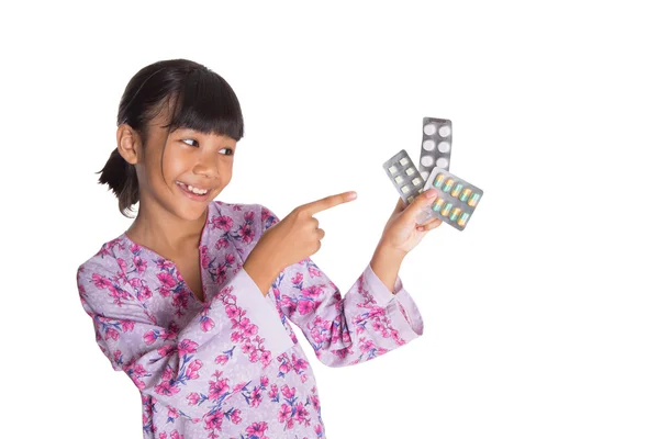 Menina jovem e comprimidos de medicina — Fotografia de Stock