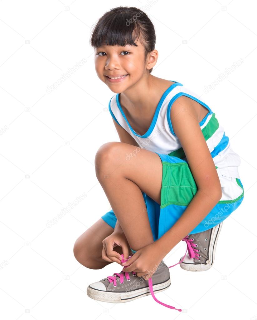 Young Girl Tying Shoe Laces