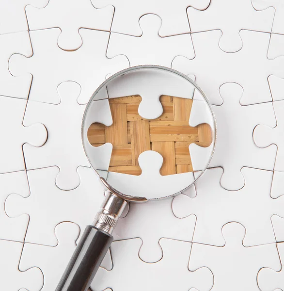 Missing Puzzle And Magnifying Glass — Stock Photo, Image
