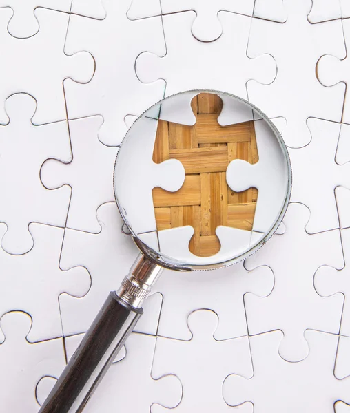 Missing Puzzle And Magnifying Glass — Stock Photo, Image