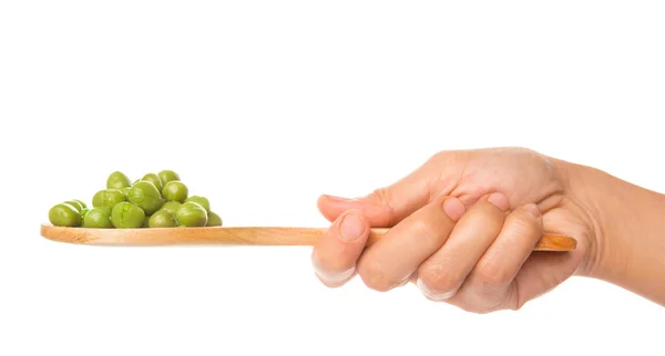 Vrouwelijke hand bedrijf groene erwten — Stockfoto