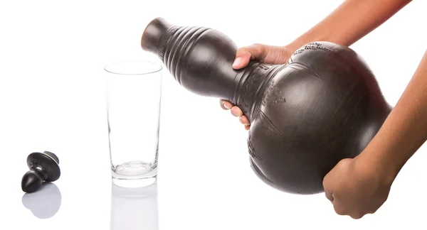 Pouring Water From Black Clay Water Pitcher — Stock Photo, Image