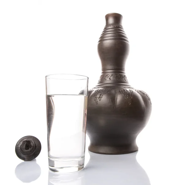 Black Clay Water Pitcher With A Glass of Water — стоковое фото