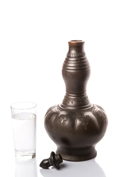 Black Clay Water Pitcher With A Glass of Water — стоковое фото