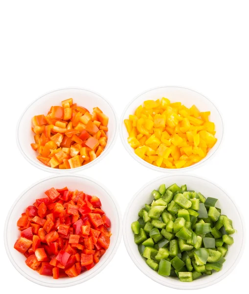 Kleurrijke gehakte paprika in witte kommen — Stockfoto
