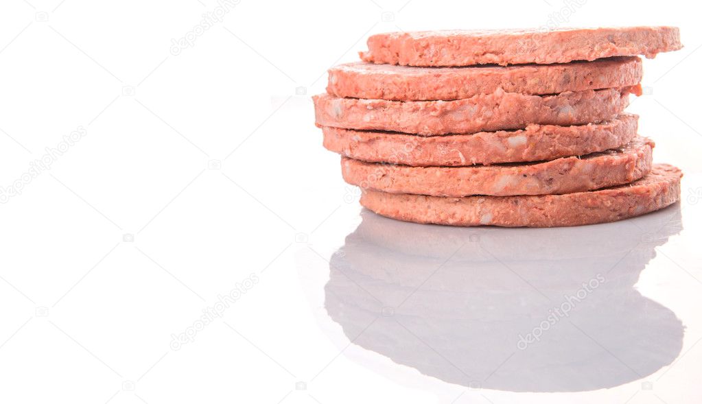 Frozen raw hamburger beef meat over white background
