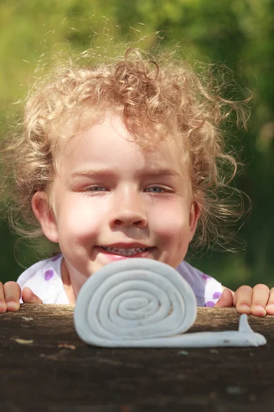 Smiling little girl with lovely curly blond hair — Stock Photo, Image