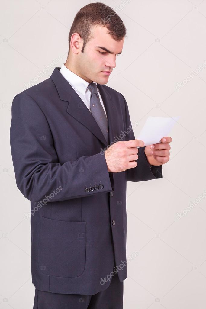 Businessman frowning as he reads a note