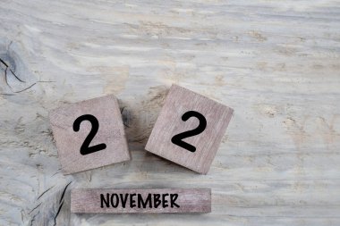 Kasım ayı için kapatma küp takvimi kopyalama alanı olan ahşap bir arkaplan üzerinde