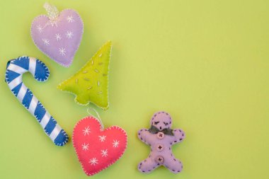 Noel, el yapımı Noel süsleri ya da yeşil yüzeyde izole edilmiş fotokopi alanı olan dekorasyonlar. Yeşil arkaplanda yeni yıl veya noel selamlaması