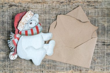 Noel kartı, Noel arkaplanı oyulmuş ayı ve boş ya da boş mektup ve ahşap yüzeyde bir zarf. Noel ya da yeni yıl tebrik kartı