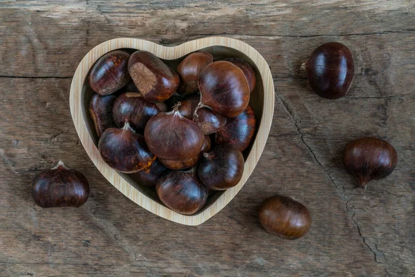 Chestnuts Ripe Raw Chestnut Fruits Heart Shaped Bowl Wooden Table — Fotografia de Stock