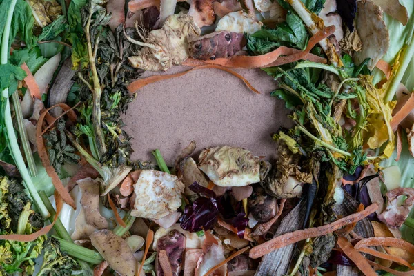 Recycle kitchen waste, Top view fruit and vegetable scraps and peels collected for zero waste concept. Sustainable living. Peeled vegetables on chopping board with copy space