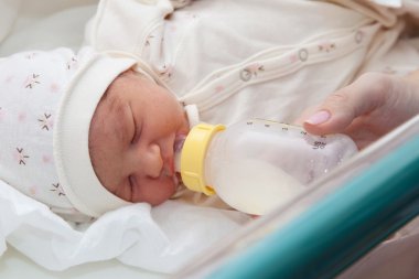 Newborn girl in the maternity hospital clipart