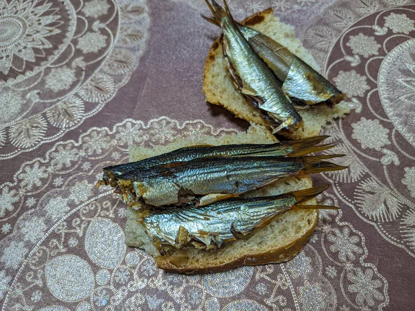 smoked fish. delicious little fish. seafood. sandwich with fish. golden fish