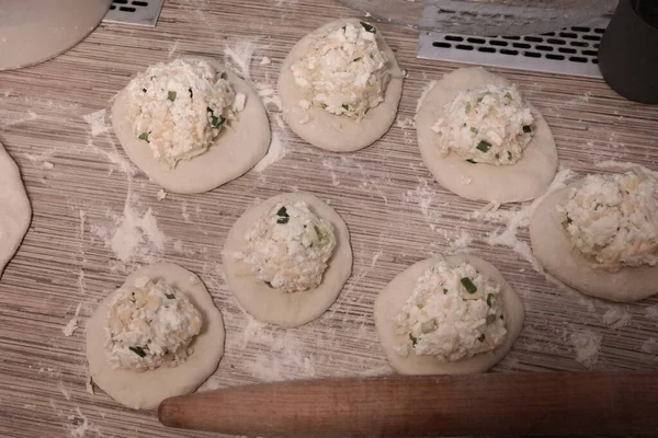 making cakes. cakes with cheese. dough. bread with cheese. cooking bread.Fried quesadillas with cheddar cheese and hot pepper in a cast iron pan. Making delicious and traditional Cheese Bread