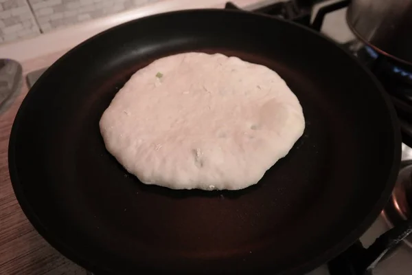 making cakes. cakes with cheese. dough. bread with cheese. cooking bread.Fried quesadillas with cheddar cheese and hot pepper in a cast iron pan. Making delicious and traditional Cheese Bread