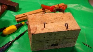 Tornavidayla çevirme. Ekip şoförü ve vidaları çalışıyor. Atölyede çalışıyorum. Tornavida metal çelik cıvatayı vidaladı. Anahtar, cıvata, vida ve fındık. Marangozluk atölyesinde ahşapla çalışmak..