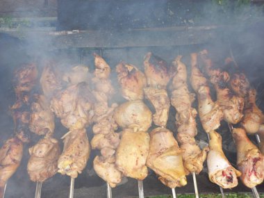 Tavuk ızgarada. Kızarmış tavuk yanıyor. Şiş üstünde et. Tavuk kebabı. ateşte et pişirmek. Ev mangalı. Izgara yemek..