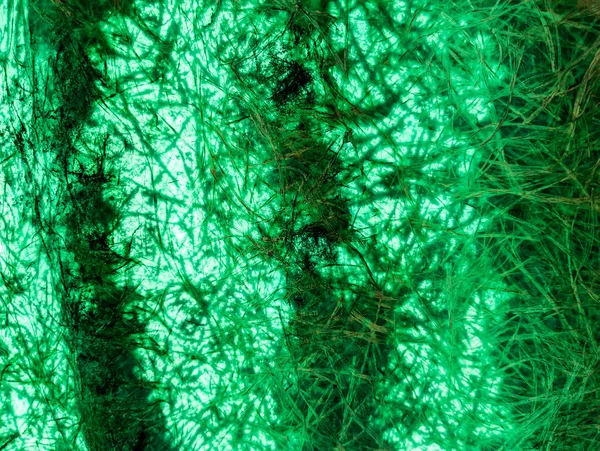 green abstract background. green fibers. Vintage green background with screen grunge pattern. Green textured paper. plastic fibers. Abstract green light trails in the dark, motion blur effect