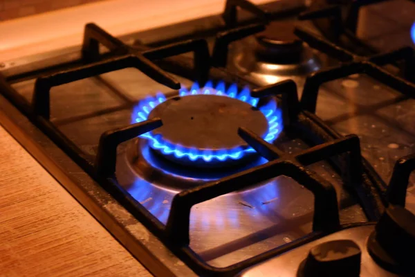 gas burns. gas hob. The gas turns on, a blue flame appears. Gas stove on a black background. The kitchen burner turns on. The top burner is ignited in a blue flame for cooking.