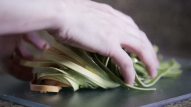 Eller tagliatelle makarnası topluyor.
