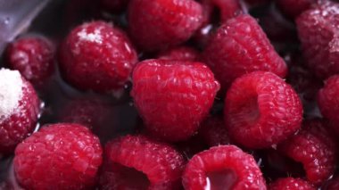 Raspberries, sugar and water in pot, just starting to boil