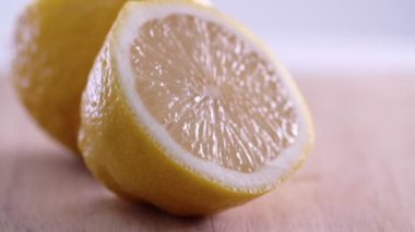 Lemon halves rotating on wooden surface