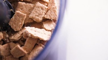 Pieces of graham crackers falling into food processor, overhead tracking shot
