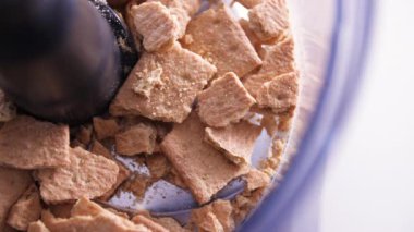 Graham crackers falling into food processor, no camera movement