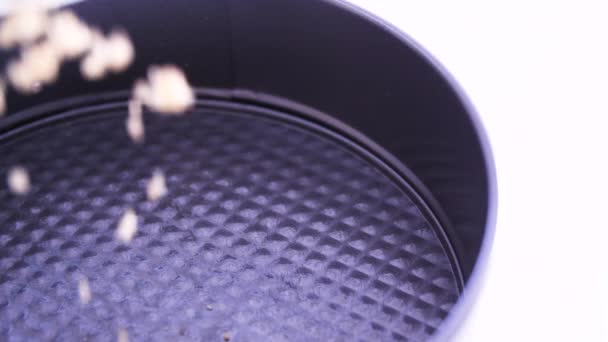 Adding Crumbled Graham Cracker Mixture Small Baking Dish Camera Movement — Stockvideo