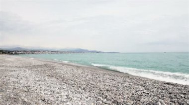 Stony coastline on French Riviera with Nice in background