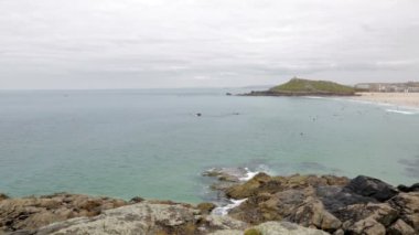 Coast and sea with view of the Island in St Ives England.