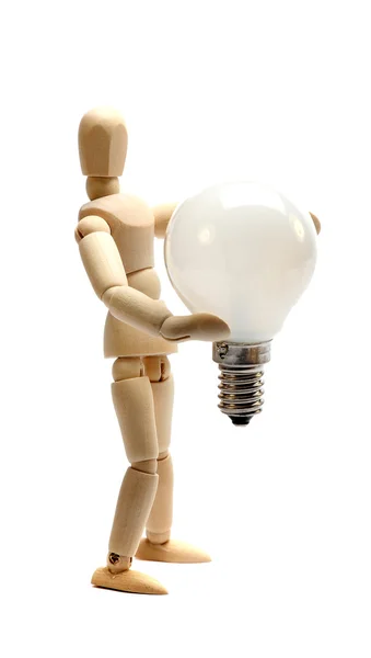 Wooden doll holding a light bulb — Stock Photo, Image