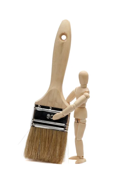 Paintbrush and wooden doll on white — Stock Photo, Image