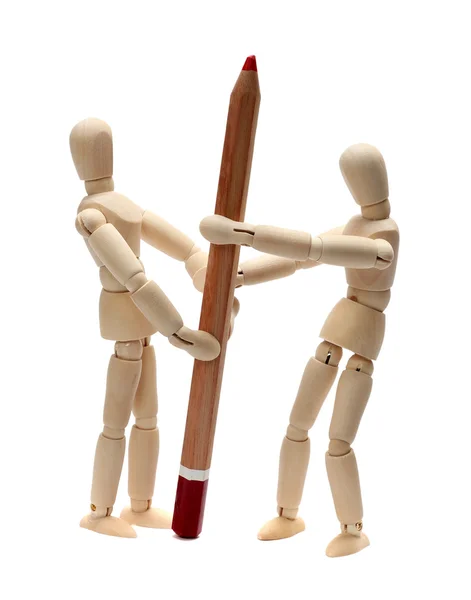 Wooden doll fighting about red pencil — Stock Photo, Image