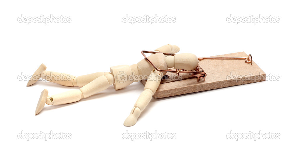 Wooden doll captured in mousetrap