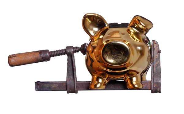 Piggy bank under pressure in old clamp — Stock Photo, Image