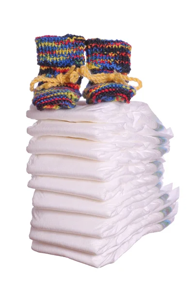 Stack of diaper with baby shoes — Stock Photo, Image