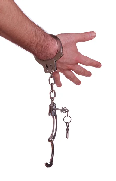 Открытые наручники под рукой — стоковое фото