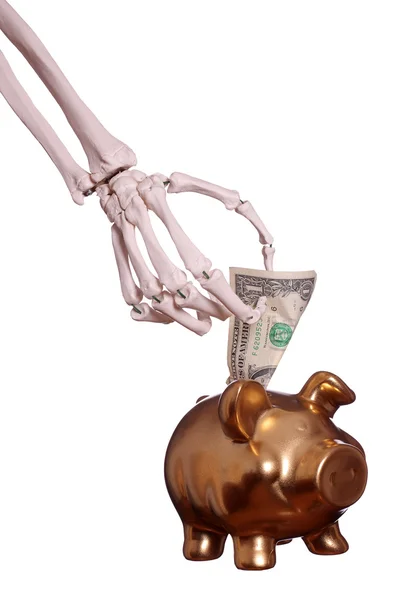 Skelett hand med dollarn och piggybank — Stockfoto