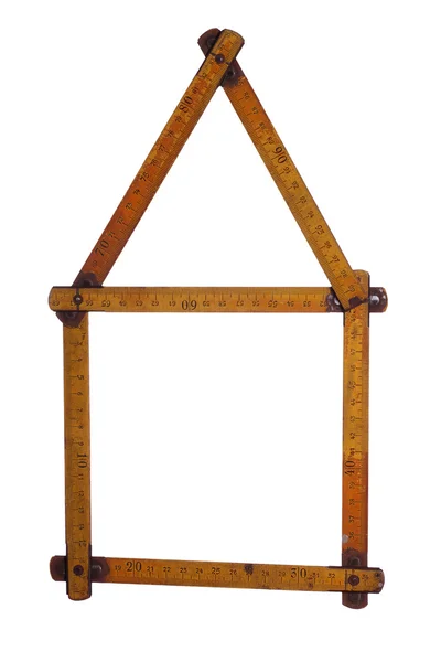 Symbol of house made of old yardstick — Stock Photo, Image