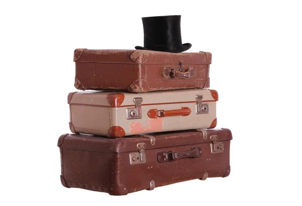 Old hat on top of stacked suitcases — Stock Photo, Image