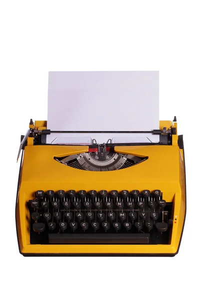 Gul skrivmaskin med vitt papper — Stockfoto