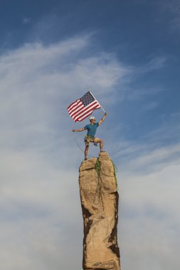 Successful climber at the top. clipart