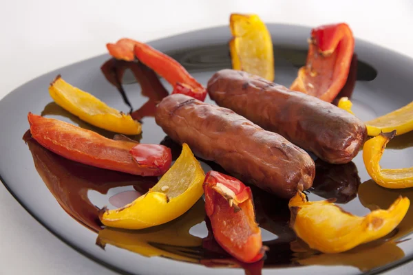 Grilled sausages and colorful peppers — Stock Photo, Image
