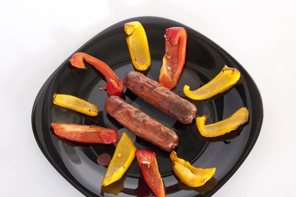 Grilled sausages and colorful peppers — Stock Photo, Image