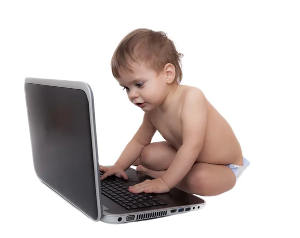 Cute baby playing with a laptop computer isolated on white — Stock Photo, Image
