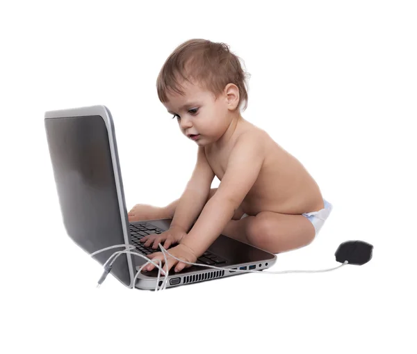 Cute baby playing with a laptop computer isolated on white — Stock Photo, Image